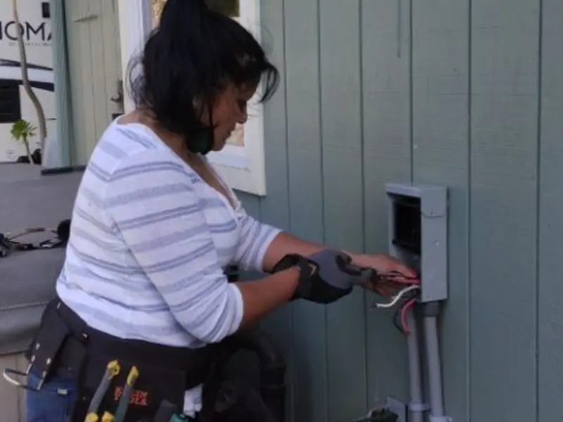 Licensed electrician wiring an exterior subpanel in Savoy