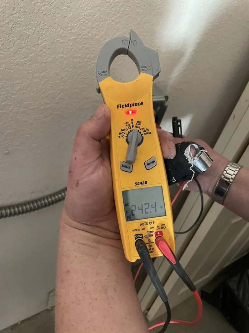 Voltage testing with clamp meter during Whole House Surge Protector in Savoy